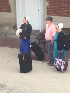 An Amish family waits at a train station